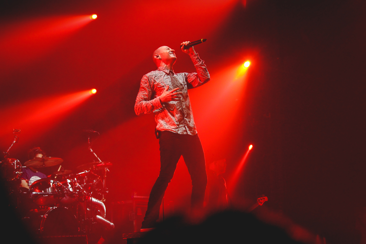 Man Wearing Grey Button-up Dress Shirt And Black Fitted Pants Holding Black Cordless Microphone